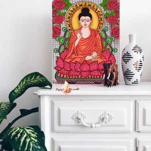 May include: A digital painting of Buddha sitting in a lotus position on a pink lotus flower. The background is a gray mandala with red roses and green peacocks. The painting is signed "Preeti's Art World".