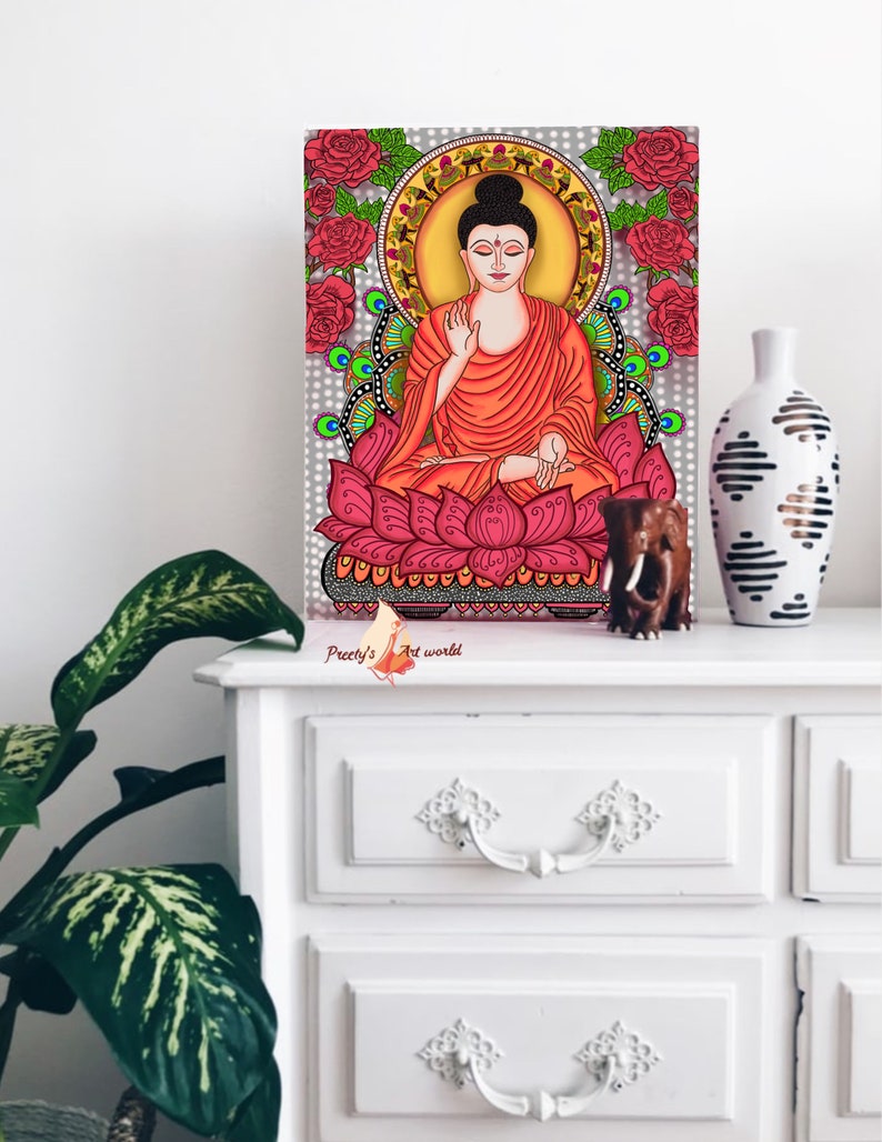 May include: A digital painting of Buddha sitting in a lotus position on a pink lotus flower. The background is a gray mandala with red roses and green peacocks. The painting is signed "Preeti's Art World".