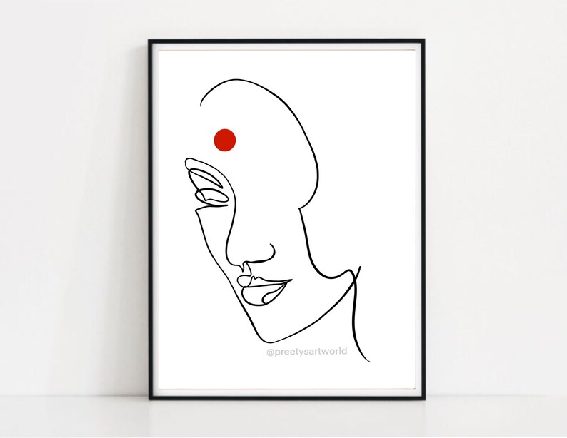 May include: Line art drawing of a woman's face with a red dot on her forehead. The drawing is in black and white and has a minimalist style. The text "@preetyartworld" is at the bottom of the image.