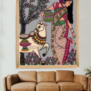 May include: A colorful illustration of a woman in a traditional Indian sari holding a pot, walking with a cow in a field of flowers. The artwork is framed in a wooden frame.
