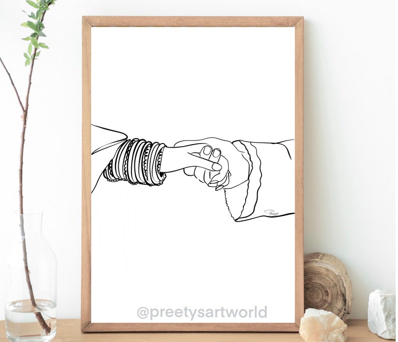May include: A black and white line drawing of two hands holding each other. One hand is adorned with multiple bangles. The drawing is on a white background and framed in a wooden frame.