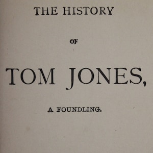 May include: The cover of a book titled "The History of Tom Jones, A Foundling." by Henry Fielding. The book is complete in one volume.