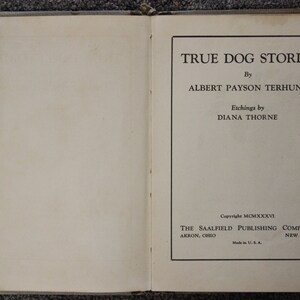 May include: The cover of a book titled "True Dog Stories" by Albert Payson Terhune. The book was published in 1936 by The Saalfield Publishing Company.