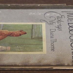 May include: A vintage book titled "True Dog Stories" by Albert Payson Terhune. The cover features a black and white etching of a dog by Diana Thorne.