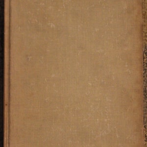 Op de afbeelding: Een bruin boek met een textuur-omslag. Het boek is licht beschadigd en heeft een paar kleine krassen.