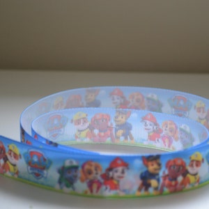Paw Dogs Puppies 7/8 inch Pups Sitting Running Grosgrain Ribbon on Boy Patrol Grass & Sky Background