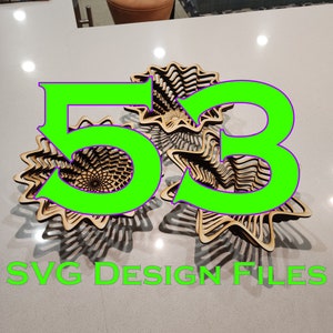 Può includere: Due ciotole di legno con un design geometrico, impilate l'una sull'altra. Le ciotole sono in legno marrone chiaro e hanno un motivo a spirale. Il testo "53 SVG DESIGN FILES" è scritto in lettere verdi su uno sfondo bianco.