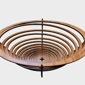 May include: A wooden bowl with a unique design. The bowl is made of multiple layers of wood that are stacked on top of each other. The bowl is a light brown colour and has a natural wood finish.