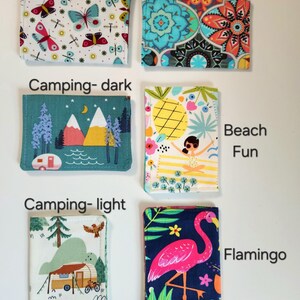 May include: Six rectangular fabric card holders featuring various prints: Butterfly, Boho, Camping-dark, Beach Fun, Camping-light, and Flamingo. Each item displays a distinct pattern including insects, geometric shapes, landscapes, and animals.