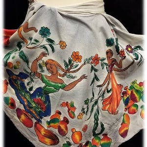May include: A white cotton skirt with a colorful floral print featuring women and pottery. The skirt has a tie closure at the waist.