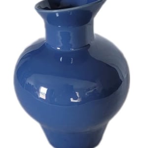 May include: A blue ceramic vase with a rounded body and a wide, flared opening. The vase has a glossy finish.