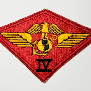 May include: A red diamond-shaped patch with a gold eagle and wings, a globe with an anchor, and the number "IV" in black.