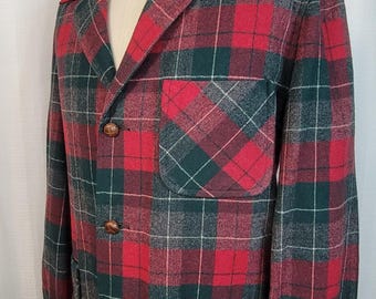 May include: A red and green plaid jacket with a button-up front and two large patch pockets. The jacket is made of a thick, woven fabric and has a classic, casual style.
