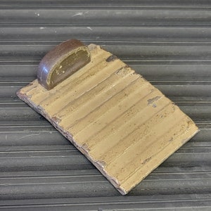 May include: A vintage, light brown, rectangular, metal, ribbed,  soap dish with a brown plastic soap holder.