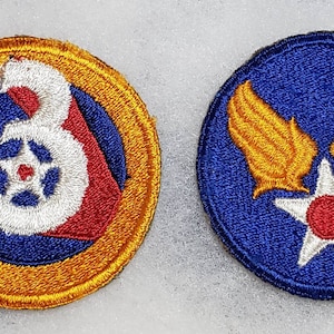 May include: Two embroidered patches, one with a blue background and a white number 3 with a red star in the center, surrounded by a gold circle, and the other with a blue background and a white star with a red center, with gold wings on either side.