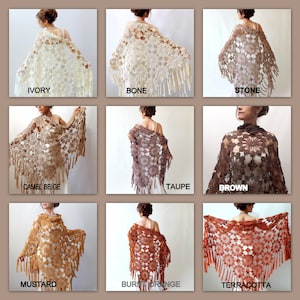 May include: Nine different crochet shawls in various colors are displayed. Colors include ivory, bone, stone, camel beige, taupe, brown, mustard, burnt orange, and terracotta. Each shawl features a floral pattern and fringe.
