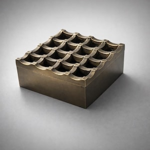 May include: A square, antique brass ashtray with a grid pattern of curved indentations. The ashtray has a low-profile design and a warm, metallic finish. The overall aesthetic is vintage and decorative.