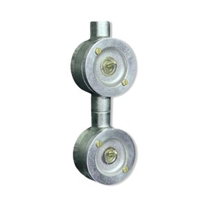 May include: A double toggle light switch assembly featuring two circular silver-toned metal housings connected by a central conduit. Each housing contains a central metal toggle switch secured by two small brass-coloured screws on the faceplate.