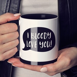 May include: White coffee mug with a black interior and a black speech bubble that says "I bloody love you!"