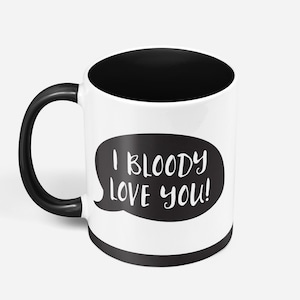 May include: White ceramic mug with a black handle and a black interior. The mug has a black speech bubble with the text "I BLOODY LOVE YOU!" in white.