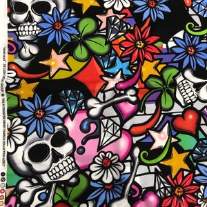 May include: A colourful fabric design featuring skulls, hearts, shamrocks, stars, and flowers. The background is black with white accents. The fabric is printed with a variety of colours, including red, green, blue, yellow, and pink.