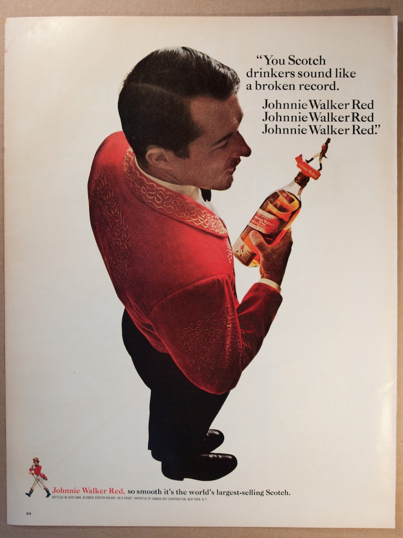 May include: A man in a red suit holds a bottle of Johnnie Walker Red Scotch whisky. The text on the ad reads "You Scotch drinkers sound like a broken record. Johnnie Walker Red. Johnnie Walker Red. Johnnie Walker Red." and "Johnnie Walker Red, so smooth it's the world's largest-selling Scotch."