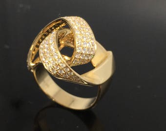 May include: A gold ring with a knot design, set with small diamonds.