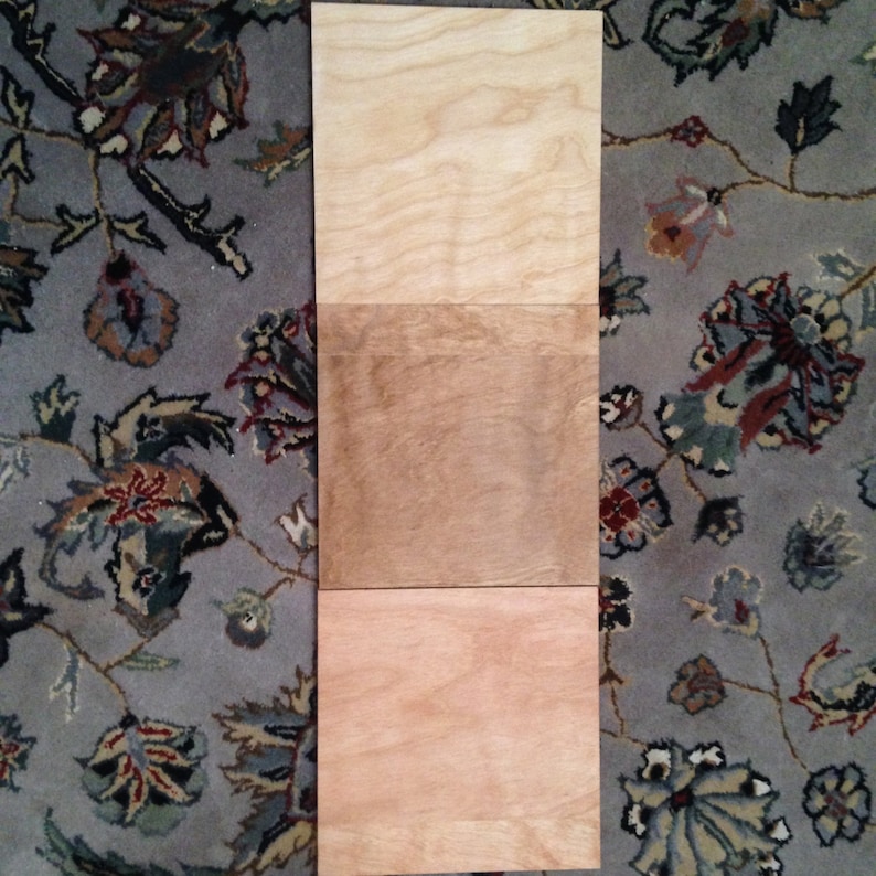 May include: Three wood samples showing different shades of brown. The top sample is the lightest, the middle sample is a medium brown, and the bottom sample is the darkest.