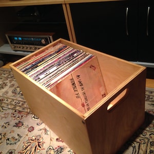 May include: A wooden record crate filled with vinyl records. The crate has a handle and is labeled "Humble Pie" and "As Safe As Yesterday, Vol. 6".