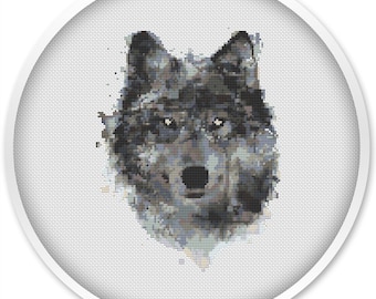 May include: A gray wolf's head is depicted in a pixelated style, resembling a cross-stitch pattern. The wolf's eyes are a dark brown, and its nose is black. The background is a light gray.