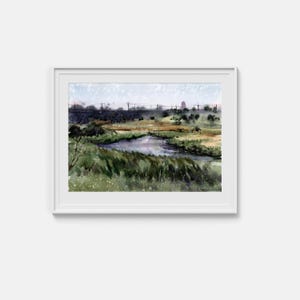 Könnte beinhalten: Ein gerahmtes Aquarell-Landschaftsgemälde, das einen gewundenen Fluss durch eine grasbewachsene Wiese mit dunklen Bäumen und einer fernen Horizontlinie unter einem blassen Himmel zeigt. Das Kunstwerk ist in einem weißen Rahmen mit Passepartout.