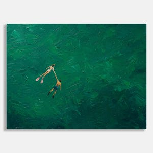 May include: An oil painting depicting two figures swimming in deep green water. One figure wears a white swimsuit and pink flippers, while the other wears blue swim trunks. The two figures are reaching out to hold hands in the center of the canvas.