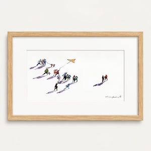 May include: A framed horizontal print featuring a watercolor illustration of small, stylized figures in various colorful outfits walking across a white space. Some figures hold balloons or pull a wagon, while one flies a yellow kite. A signature is in the corner.