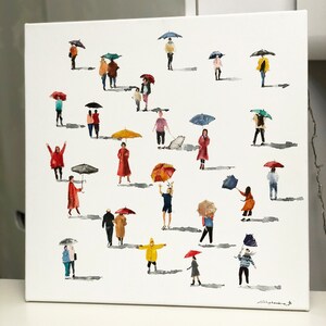 May include: A watercolor painting of people walking in the rain with umbrellas. The painting features a variety of colors, including red, blue, yellow, green, and purple. The people are all wearing different clothes and carrying umbrellas of different sizes and colors. The painting is set against a white background.
