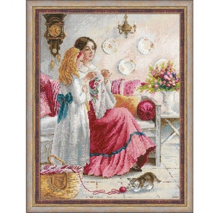 May include: Two women are seated on a sofa in a vintage-style room, one woman is wearing a pink dress and the other is wearing a white dress. A cat is sitting on the floor in front of them.