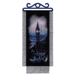 May include: A cross-stitch tapestry depicting the illuminated Big Ben clock tower at night. The artwork features a dark blue and black color scheme with accents of pink and white in the sky. The tapestry has a dark blue decorative top and fringe.