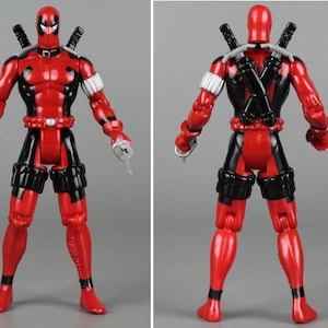 May include: A red and black action figure of Deadpool, a Marvel Comics superhero. The figure has a black mask, a red and black suit, and two swords on its back.