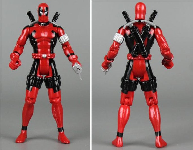 May include: A red and black action figure of Deadpool, a Marvel Comics superhero. The figure has a black mask, a red and black suit, and two swords on its back.