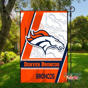 May include: A garden flag featuring the Denver Broncos logo. The flag has a white background with the team's logo in the center. The flag also has the words "DENVER BRONCOS" and "BRONCOS" in white text on an orange background.