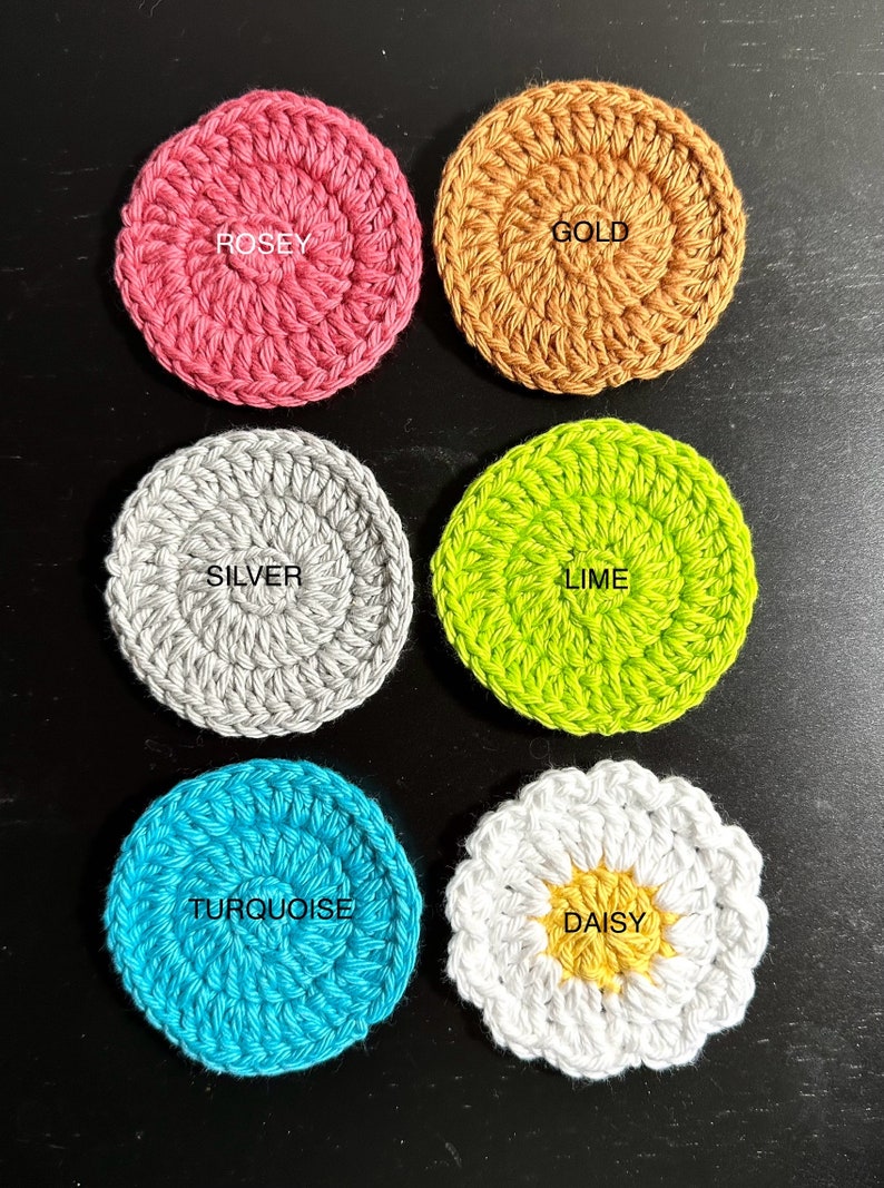 May include: Six crocheted coasters in various colours and designs. The coasters are labelled "Rosey", "Gold", "Silver", "Lime", "Turquoise", and "Daisy".