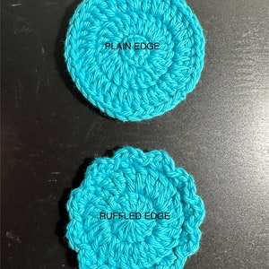 May include: Two crocheted coasters, one with a plain edge and one with a ruffled edge. Both coasters are turquoise blue.