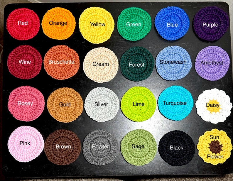 May include: A set of 24 crocheted coasters in various colours and patterns, including red, orange, yellow, green, blue, purple, wine, bruschetta, cream, forest, stonewash, amethyst, rose, gold, silver, lime, turquoise, daisy, pink, brown, pewter, sage, black, and sun flower.