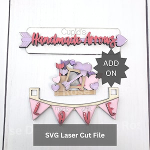 May include: Valentine's Day themed laser cut file with the text "Cupid's Handmade Arrows" on an arrow-shaped sign. Includes a banner that reads "made with LOVE" and a Cupid and arrow design. The file is labeled "SVG Laser Cut File".
