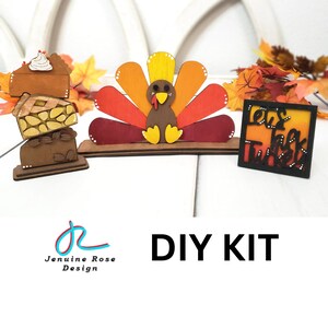 May include: DIY craft kit featuring a wooden turkey napkin holder, a stack of wooden pie slices, and a wooden sign that says "Let's Talk Turkey".