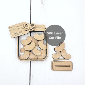 Op de afbeelding: Een houten knutselset om een ​​konijnenlokaaspot te maken. De set bevat een pot, een deksel, jelly bean vormen en een bord met de tekst "Bunny Bait".