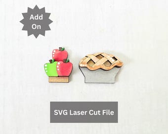 May include: Two wooden laser-cut shapes featuring a stack of red and green apples and a lattice-crust pie. A gray starburst icon contains the text Add On, and a gray rectangle contains the text SVG Laser Cut File. The items have flat surfaces.