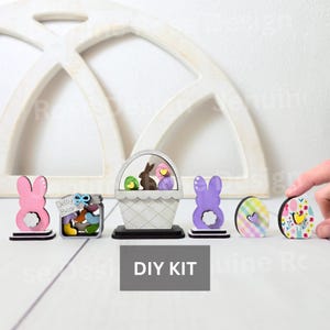 May include: DIY Easter craft kit with a basket, bunny, eggs, and jelly bean jar. The kit includes wooden cutouts and instructions for assembling the pieces.
