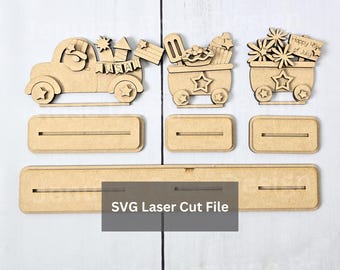 May include: Laser-cut wooden Fourth of July decorations. The set includes a truck, two wagons, and three rectangular bases. The truck has a USA banner and fireworks. The wagons are decorated with ice cream, cupcakes, and flowers. The text "Happy 4th of July" is visible.