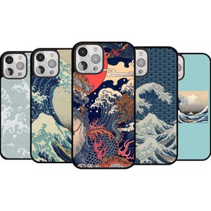 May include: A collection of phone cases featuring Japanese-inspired art. Designs include stylized waves, a dragon, and a red sun. The cases have black borders and are in various shades of blue, beige, and red.