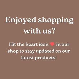 May include: A brown background with white text that reads, "Enjoyed shopping with us?" Below, it says, "Hit the heart icon in our shop to stay updated on our latest products!" A red heart icon is included.